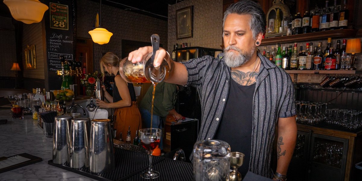 Bartender at Bar Americano pouring a drink in Edmonds